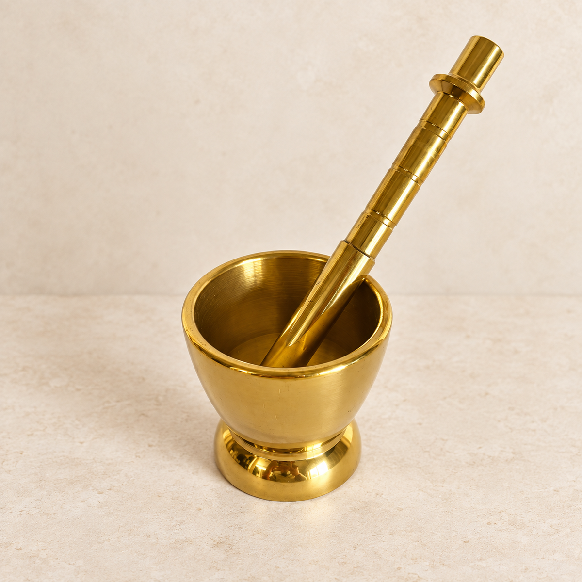 Mortar and pestle on a pale stone surface